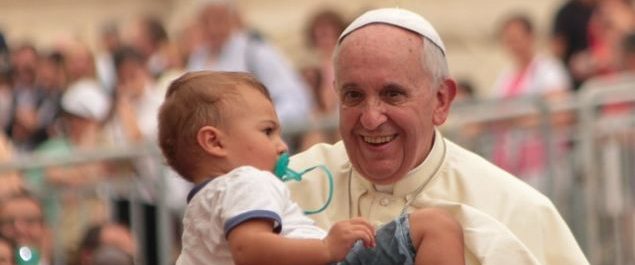 Papst Franziskus segnet ein Kind.