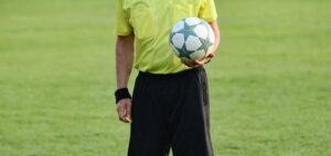 Ein Schiedsrichter, der einen Ball hält.